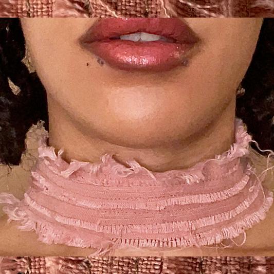 Close-up of a person wearing a textured pink garment with a neutral background
